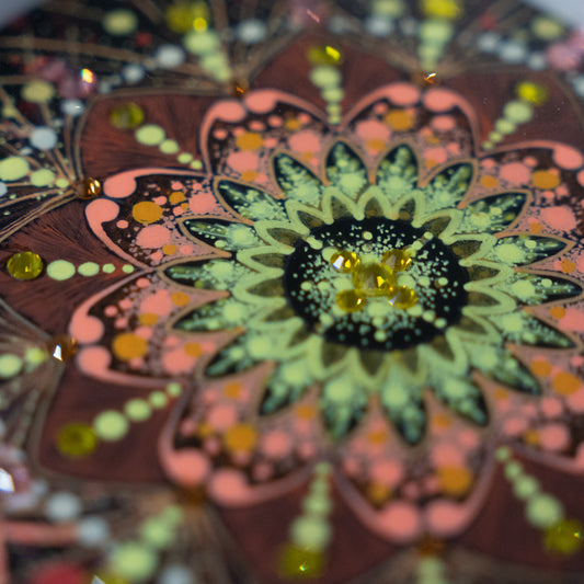 額装された曼荼羅「オレンジ色は元気になる」。見る人に元気を与えるような明るく躍動感ある模様が描かれている。|Japan Satsuma